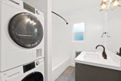 Thumbnail 30 of 43 - a washer and dryer in a bathroom next to a tub and a sink