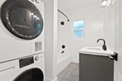 Thumbnail 40 of 43 - a washer and dryer in a laundry room with a sink and a tub