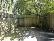 Thumbnail 11 of 16 - a backyard with a wooden fence and a tree