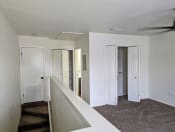 Thumbnail 9 of 16 - a living room with white walls and white doors and a ceiling fan