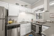Thumbnail 45 of 52 - a kitchen with white cabinets and stainless steel appliances