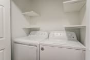 Thumbnail 13 of 31 - a washer and dryer in a laundry room