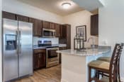 Thumbnail 11 of 26 - a kitchen with stainless steel appliances and a granite counter top
