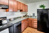 Thumbnail 6 of 16 - Kitchen with Black Appliances at Kenilworth at Charles Apartments, Towson, MD