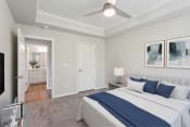 Thumbnail 4 of 27 - a bedroom with a large bed and a ceiling fan at The Bluestone Apartments, South Carolina