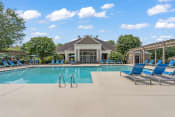 Thumbnail 22 of 41 - a resort style pool with lounge chairs and a clubhouse in the background at Fortress Grove, Murfreesboro, Tennessee