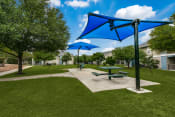 Thumbnail 8 of 13 - a picnic area with picnic tables and umbrellas