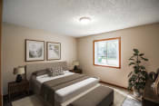 Thumbnail 3 of 16 - a bedroom with a bed and a window. Bismarck, ND Eastbrook Apartments.