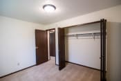 Thumbnail 14 of 16 - A bedroom with a closet. Bismarck, ND Eastbrook Apartments.