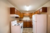 Thumbnail 6 of 16 - Bismarck, ND Eastbrook Apartments. A kitchen with a stove refrigerator and sink