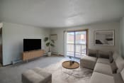 Thumbnail 4 of 16 - A living room with a couch and a coffee table. Bismarck, ND Eastbrook Apartments.