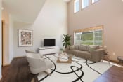 Thumbnail 3 of 11 - Bismarck, ND Stonefield Townhomes. The large room showcases comfortable seating, modern decor, and natural lighting, creating a welcoming and relaxing space for residents.