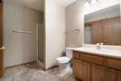 Thumbnail 8 of 10 - Omaha, NE Deerfield Apartments. A bathroom with a toilet sink and shower