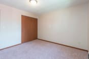 Thumbnail 5 of 6 - Spacious Room with Carpeting at Parkview Arms Apartments in Bismarck, ND