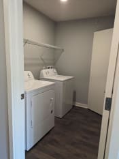 Thumbnail 6 of 115 - a laundry room with two washes and a dryer