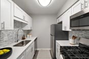 Thumbnail 22 of 64 - a kitchen with stainless steel appliances and white cabinets