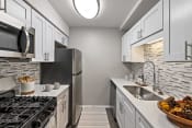 Thumbnail 8 of 64 - a kitchen with stainless steel appliances and white cabinets