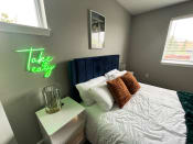 Thumbnail 16 of 50 - a bedroom with a bed and a nightstand with a glass on itat Centerpointe Apartments, Canandaigua, 14424
