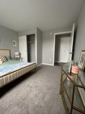 Thumbnail 22 of 50 - a bedroom with a bed and a dresserat Centerpointe Apartments, Canandaigua