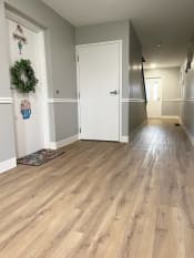 Thumbnail 29 of 50 - a picture of a hallway with hardwood floors and a white doorat Centerpointe Apartments, New York, 14424