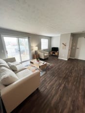 Thumbnail 13 of 50 - a living room with hardwood floors and a sliding glass doorat Centerpointe Apartments, Canandaigua, NY, 14424