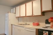 Thumbnail 7 of 79 - a kitchen with white cabinets and a sink and a refrigerator at Willowbrooke Apartments, Brockport, 14420