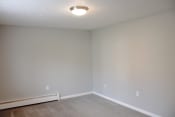 Thumbnail 19 of 79 - an empty living room with white walls and a ceiling light at Willowbrooke Apartments, Brockport, 14420