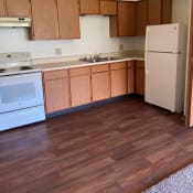 Thumbnail 8 of 10 - a kitchen with wood floors and white appliances