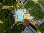 Thumbnail 10 of 37 - an aerial view of a backyard with a large swimming pool with blue and yellow umbrellas