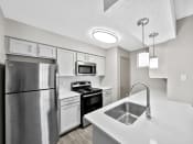 Thumbnail 27 of 37 - a kitchen with white cabinets and stainless steel appliances