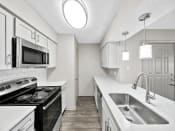 Thumbnail 3 of 37 - a kitchen with white cabinets and a stainless steel sink