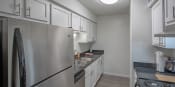 Thumbnail 4 of 26 - a kitchen with stainless steel appliances and white cabinets