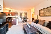Thumbnail 7 of 23 - a living room and kitchen with a couch and a coffee table  at Aventura at Mid Rivers, St. Charles