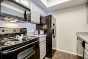 Thumbnail 18 of 22 - Modern Kitchen With Custom Cabinet at Trinity Village Apartments, Texas, 75287