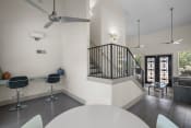 Thumbnail 11 of 58 - a living room with white walls and a staircase with black railings  at Vesper, Dallas