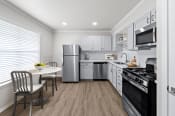 Thumbnail 3 of 55 - a kitchen with white cabinetry and stainless steel appliances  at Sunset Heights, San Antonio, TX, 78209