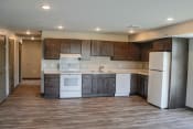 Thumbnail 24 of 54 - a kitchen with white appliances and dark wood cabinets