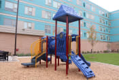 Thumbnail 8 of 54 - a playground at an apartment building with a blue playset
