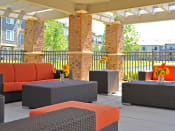 Thumbnail 7 of 33 - Shaded Outdoor Lounge Area at Prairie Lakes Apartments, Peoria, IL, 61615