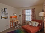 Thumbnail 13 of 13 - Spare bedroom with futon orange bed, lamp in right corner and red pattern curtains on window.
