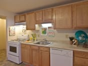 Thumbnail 5 of 13 - Light wood cabinets and white appliances in kitchen