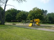 Thumbnail 15 of 17 - Playscape area in a park with trail and trees