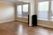 Thumbnail 31 of 38 - an empty room with hardwood floors and three windows