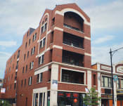 Thumbnail 1 of 23 - a tall red brick building with a rounded top