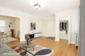Thumbnail 6 of 38 - a living room with white walls and hardwood floors