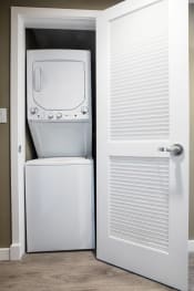 Thumbnail 15 of 24 - a washer and dryer in a room with a door that is open