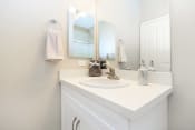 Thumbnail 57 of 60 - a white bathroom with a sink and a mirror