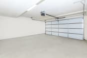 Thumbnail 60 of 60 - an empty garage with a white wall and a white garage door