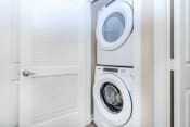 Thumbnail 58 of 60 - a white washer and dryer in a laundry room with a door