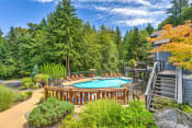 Thumbnail 19 of 57 - Apartments for Rent in Issaquah WA - Lakemont Orchard - Gated Pool Surrounded by Lounge Seating